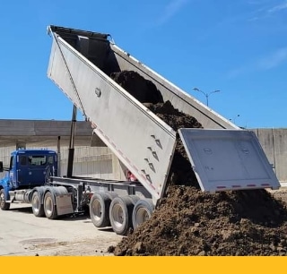 Clymore Trucking truck dumping soil